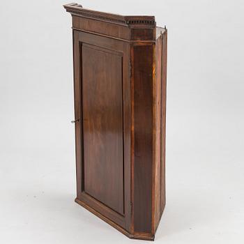 A 19th Century wall mounted corner cabinet.