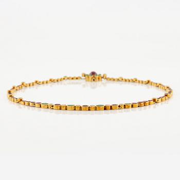 Andrew Grima, collier 18K guld med runda briljantslipade diamanter samt rubiner och smaragder.