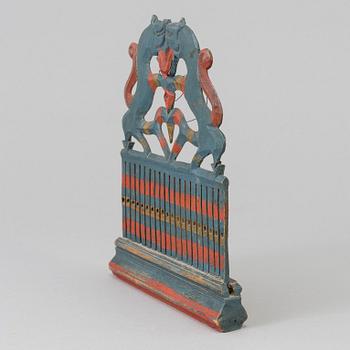 a painted wooden loom from the 19th century.