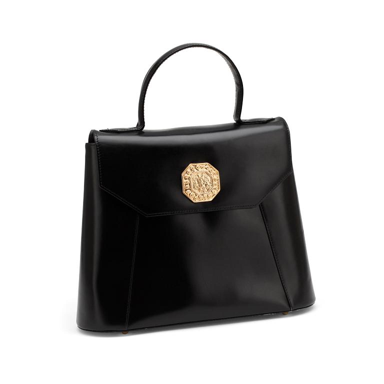 YVES SAINT LAURENT, a black leather top handle bag.