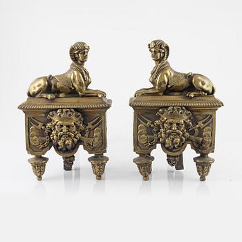 A pair of French 19th century bronze fire dogs.