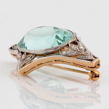 An 18K gold and platinum brooch set with a faceted aquamarine weight ca 34.00 cts.