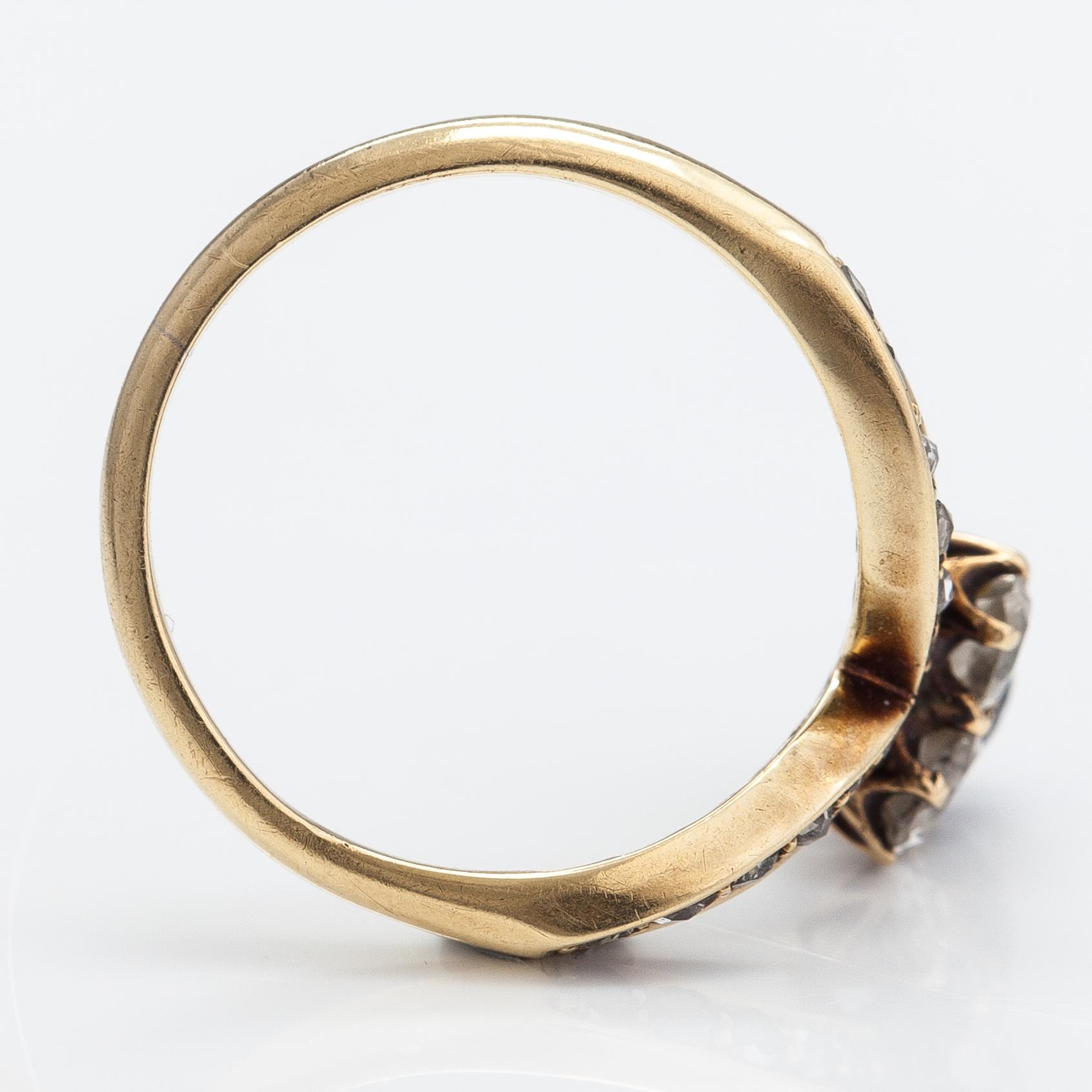 A 14K gold ring with a synthetic sapphire, radiant-cut diamonds ca. 0.28 ct in total and rose cut diamonds.