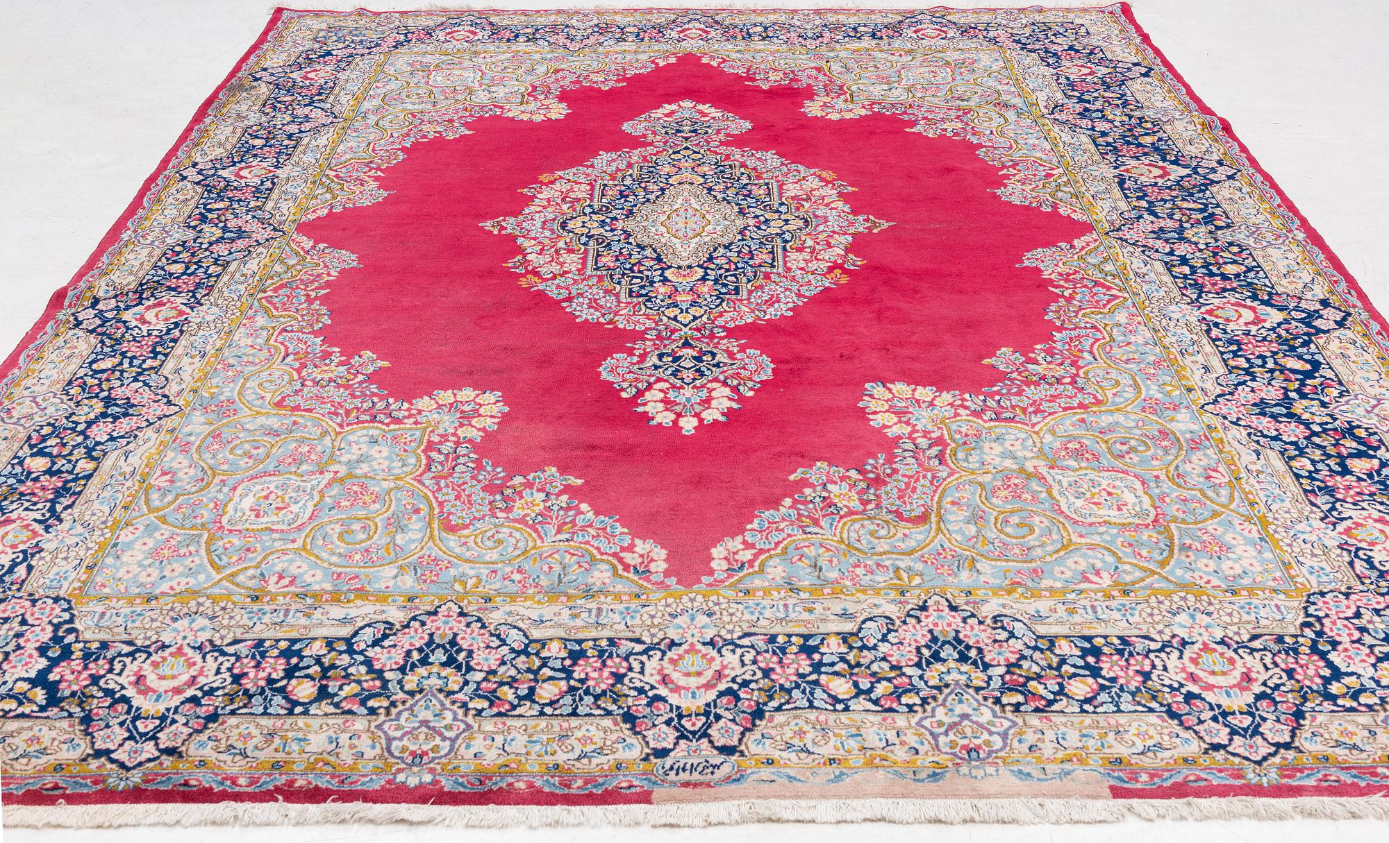 A Kirman carpet, signed, c. 388 x 279 cm.