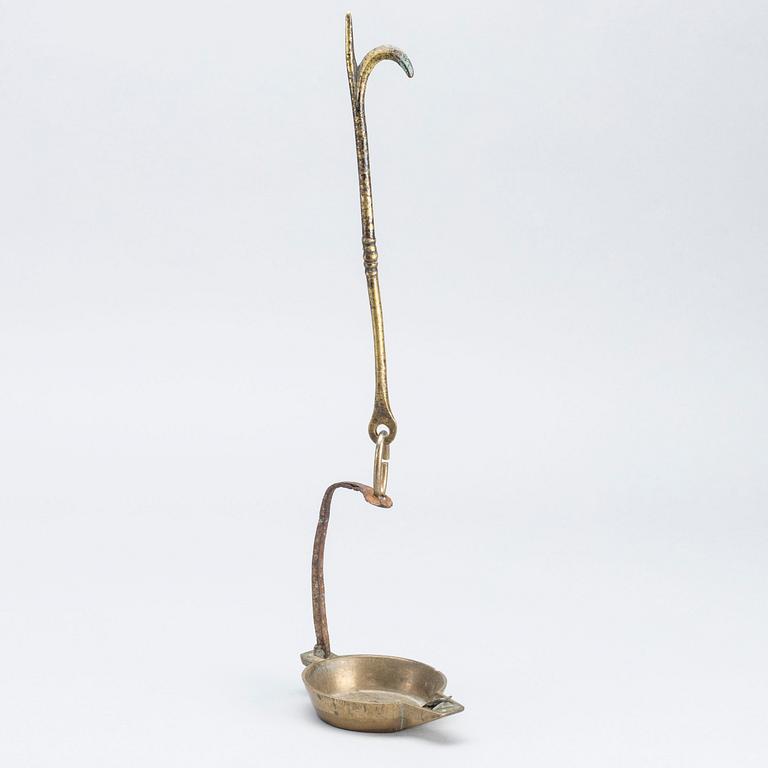 A 18th century oil lamp.