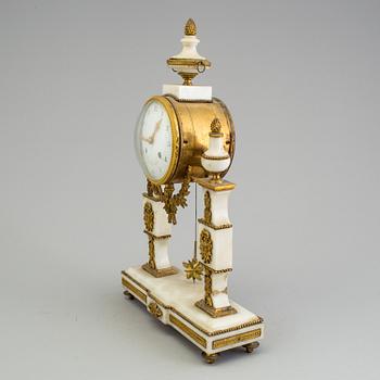 A Louis XVI marble and bronze mantel clock from the second half of the 18th century.