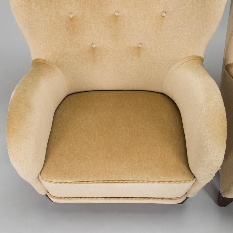 A pair of mid-20th century armchairs.