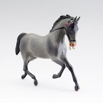 A painted tinplate toy horse ca year 1900.