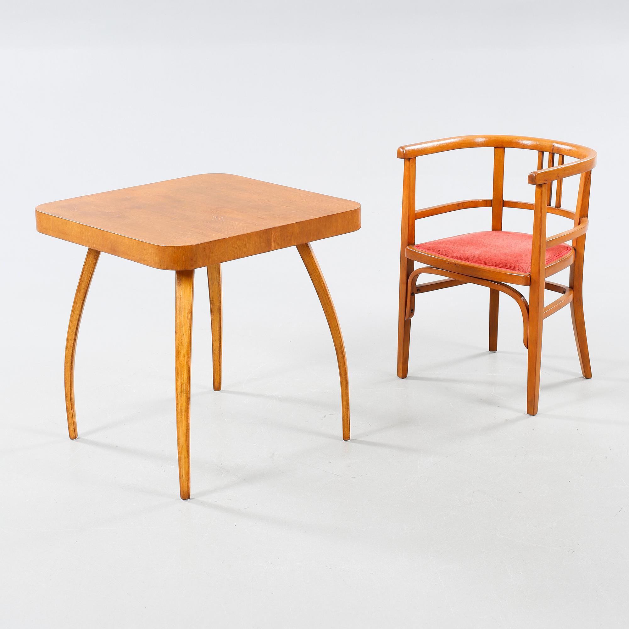 A table and a arm chair from the second quarter of the 20th century.