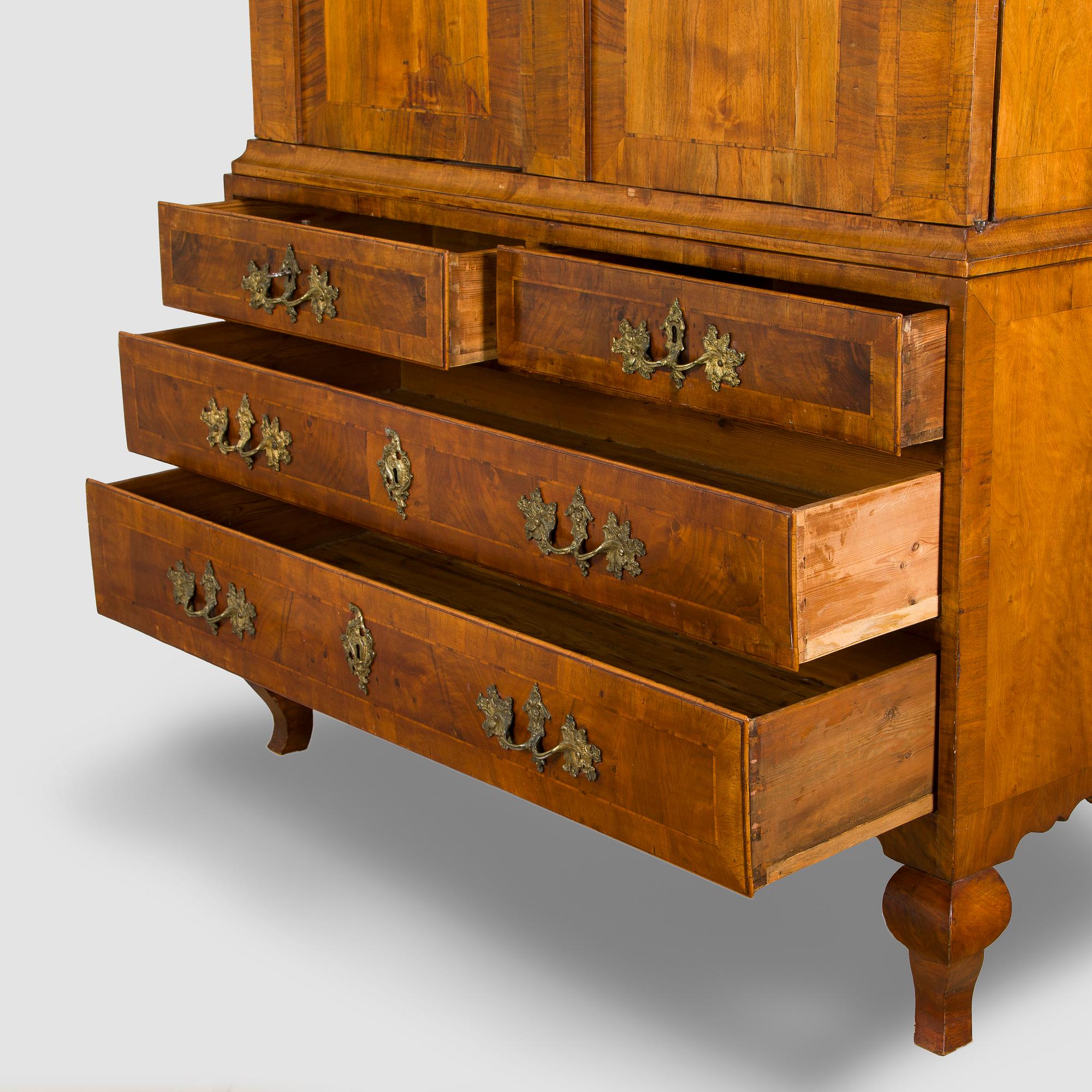 A Swedish walnut-veneered rococo cabinet in the manner of C. Linning, latter half of the 18th Century.