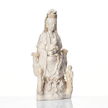 A Chinese blanc de chine Guanyin with attendants, Dehua, late Ming dynasty/early Qing dynasty.