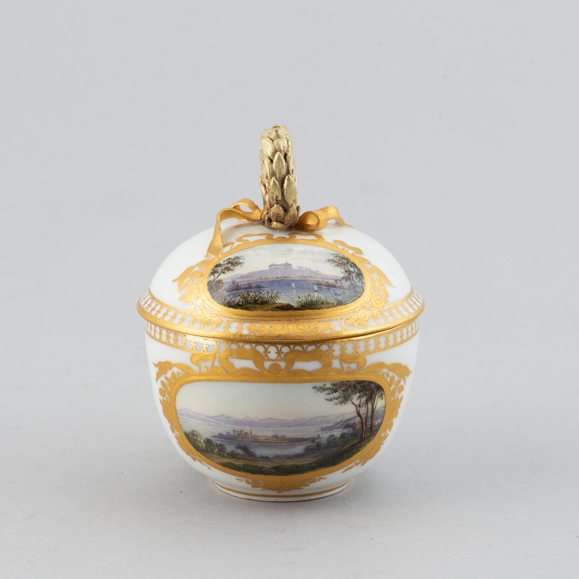 A 19th century Meissen miniature lidded porcelain cup decorated with views of Mainau.