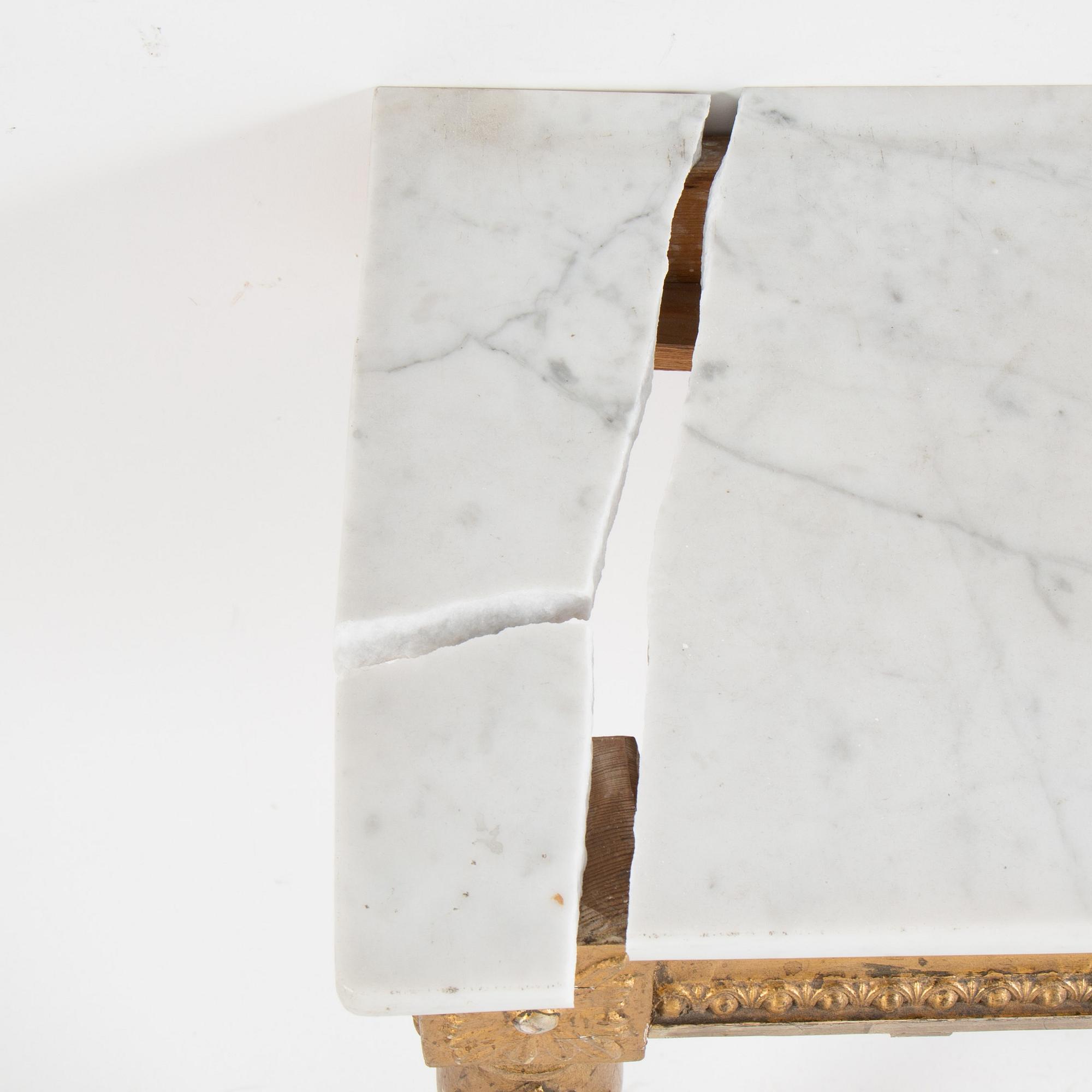 A Swedish Gustavian style mirror and console table with marble top from the first half of the 20th century.
