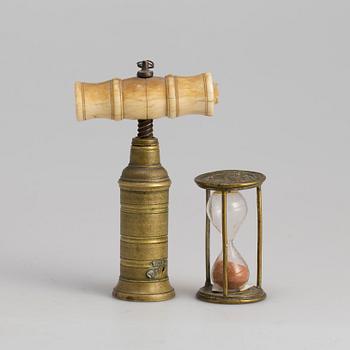 A brass cork screw and hourglass 19th century.