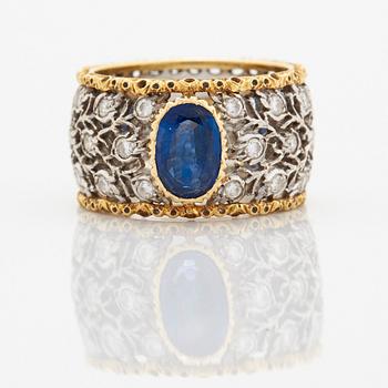 A Buccellati ring in 18K gold and white gold set with a faceted sapphire and round brilliant-cut diamonds.