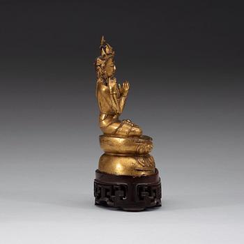 A gilt copper alloy figure of Sukhavati Avalokiteshvara seated on a high lotus base, Tibet, 15th/16th Century.