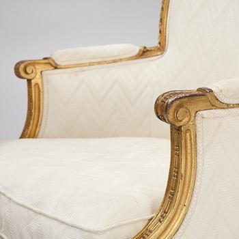 A near pair of French Louis XVI giltwood bergères, Paris, late 18th century.