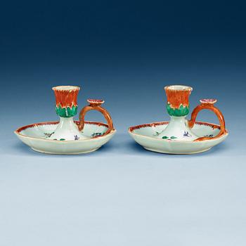 A pair of famille rose candle sticks, Qing dynastin, Qianlong (1736-95).