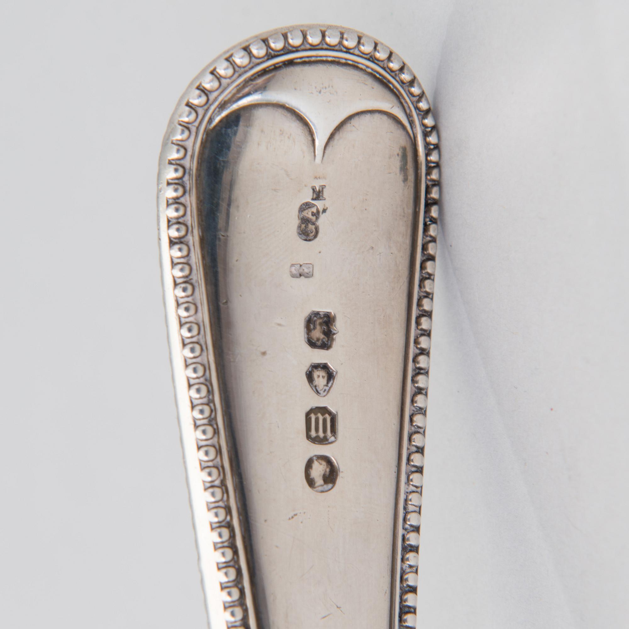 A soup ladle in sterling silver, mark of George William Adams, London 1867.