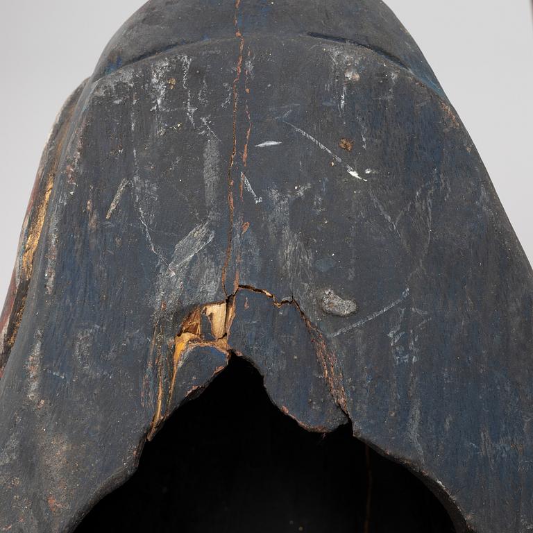 Four Tibetan/South East Asian wooden decorations, 20th century.