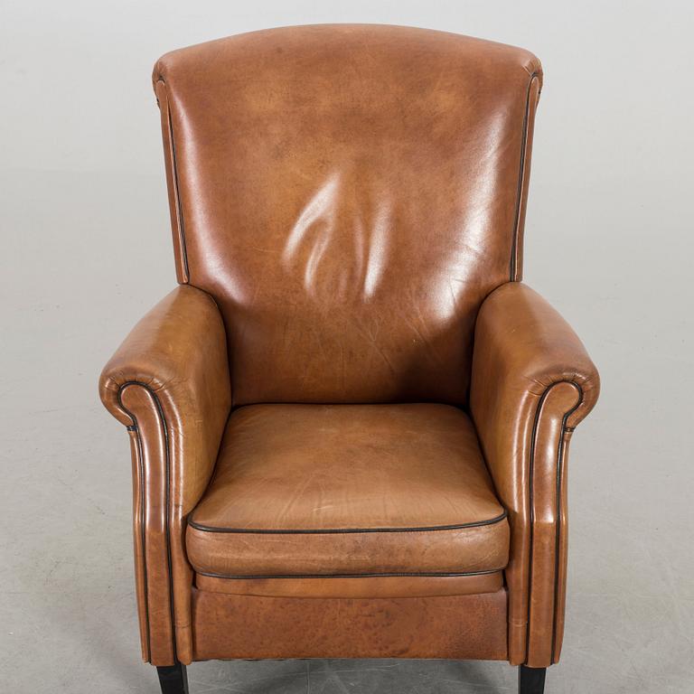 A LEATHER ARMCHAIR.