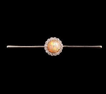 354. A BROOCH, Brilliant cut diamonds c. 0.65 ct, Opal 10 mm. 14K gold. Unmarked. Length 85 mm, weight 8,2 g.