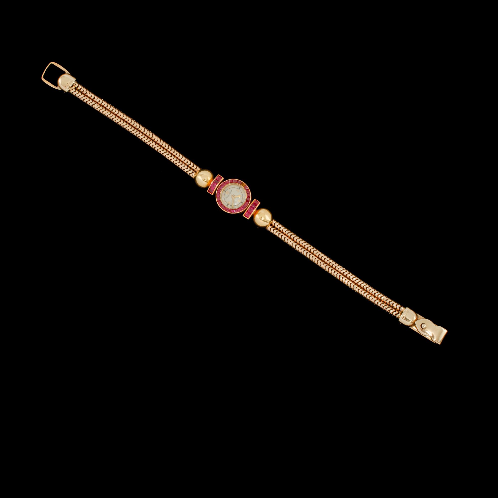 ARMBANDSUR, 18K samt 8K guld med fasettslipade rubiner, Jaeger-LeCoultre, 1900-talets första hälft.