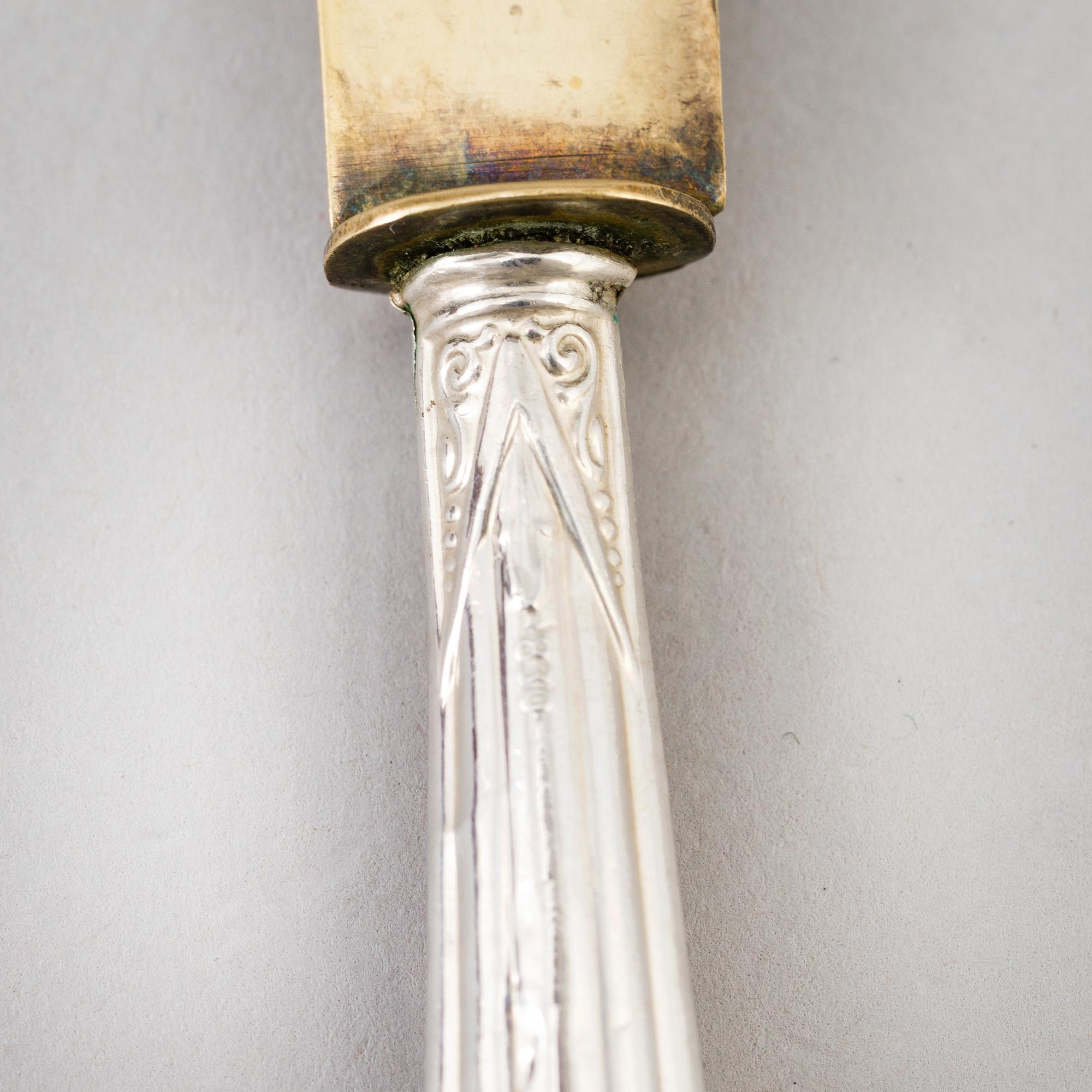 A set of twelve parcel-gilt silver fruite knives from the late 19th century.