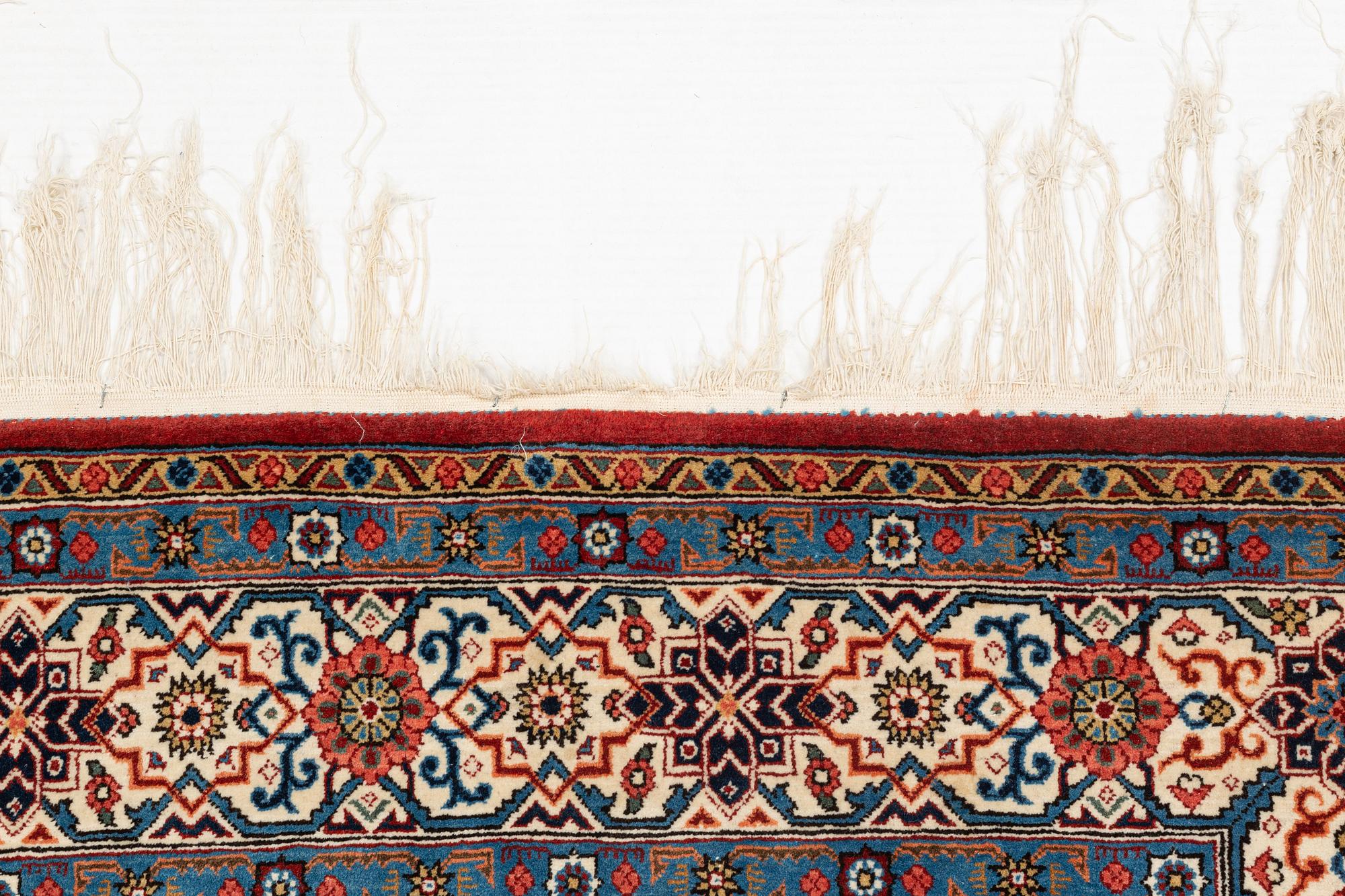 A carpet, semi-antique, Qum, ca 324 x 221 cm.