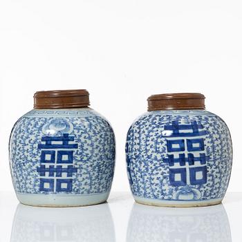 A pair of Chinese blue and white porcealin jars with wooden covers, Qing dynasty, 19th Century.