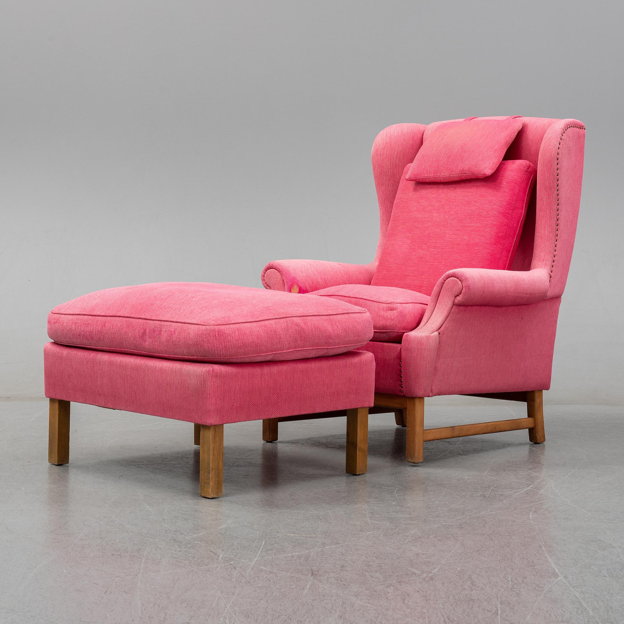 An 'Oxford' model no 3543 easy chair with stool by Ragnar Helsén for Firma Svenskt Tenn.