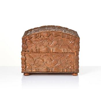 A baroque wedding casket, carved wood, dated 1725.