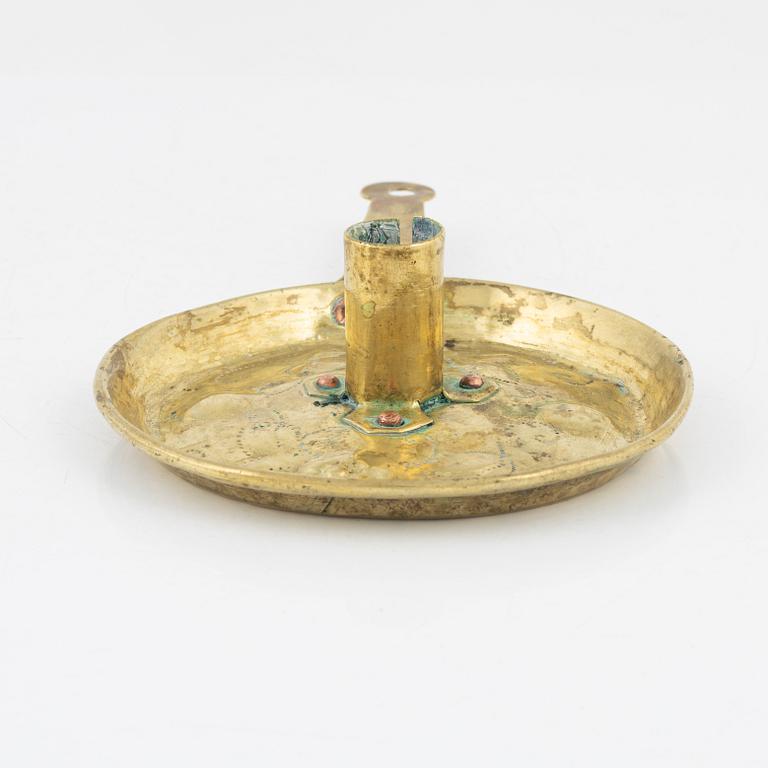 A repousse brass baroque candlestick, circa 1700.