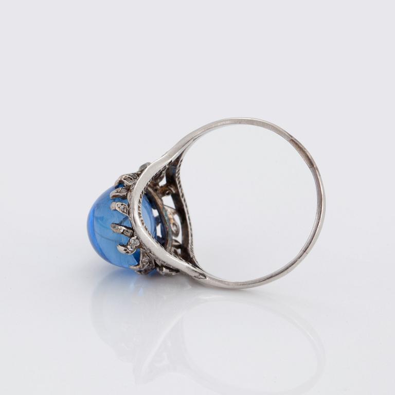 A RING set with a cabochon-cut sapphire.