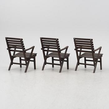 Carl Malmsten, a set three stained pine armchairs, Igelstaverken, second half of the 20th Century.