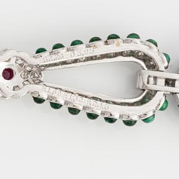 Brooch, white gold with cabochon-cut emeralds, rubies, sapphires, and brilliant- and square-cut diamonds.