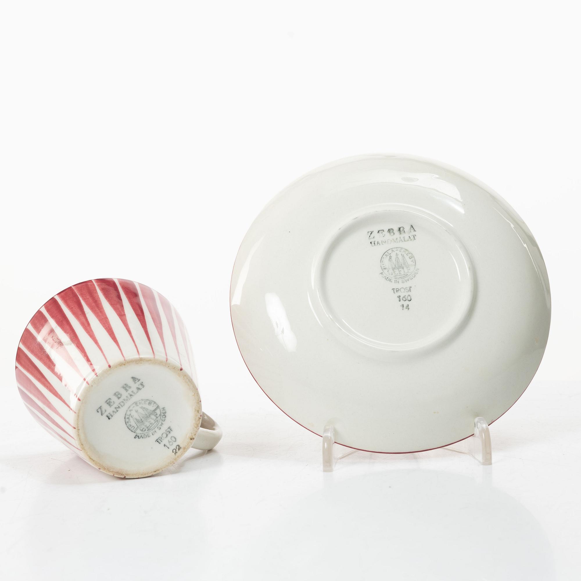 Eugen Trost, Three 'Red Zebra' cream-ware coffee cups on saucers, Uppsala-Ekeby Gefle.