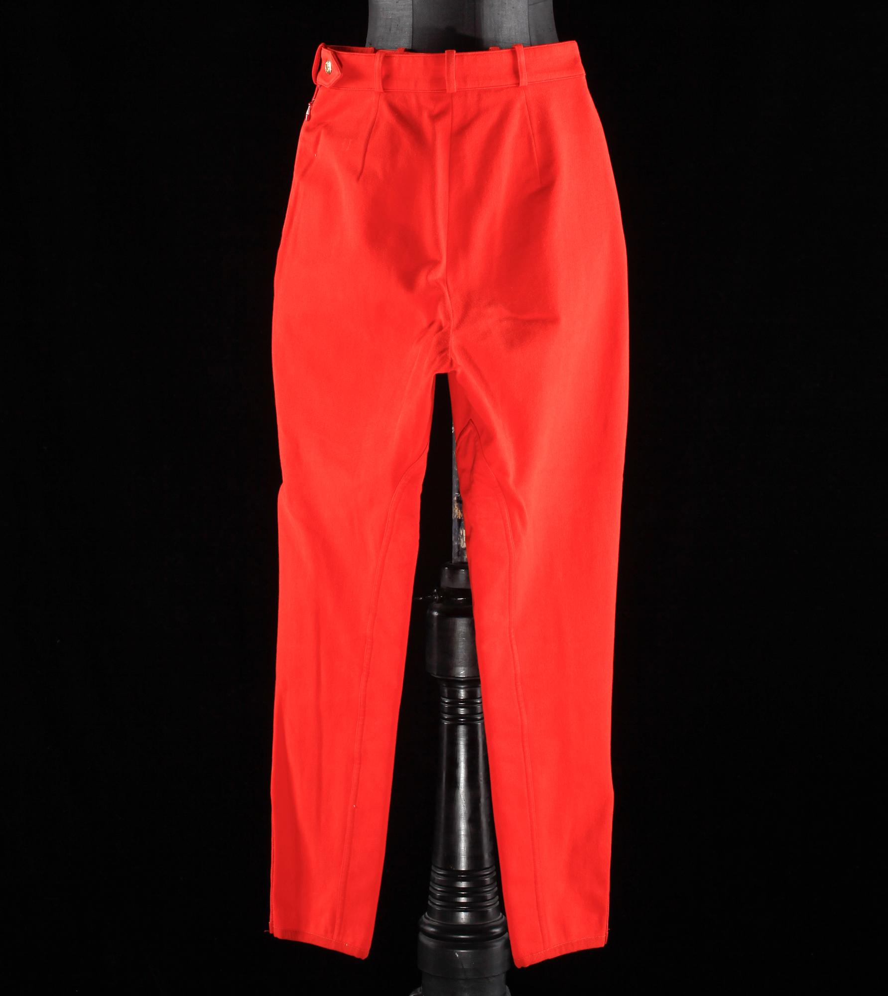 A pair of orange trousers by Hermès.