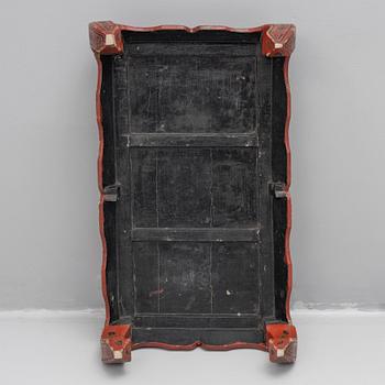 A Chinese red lacquered table, first quater of the 20th century.