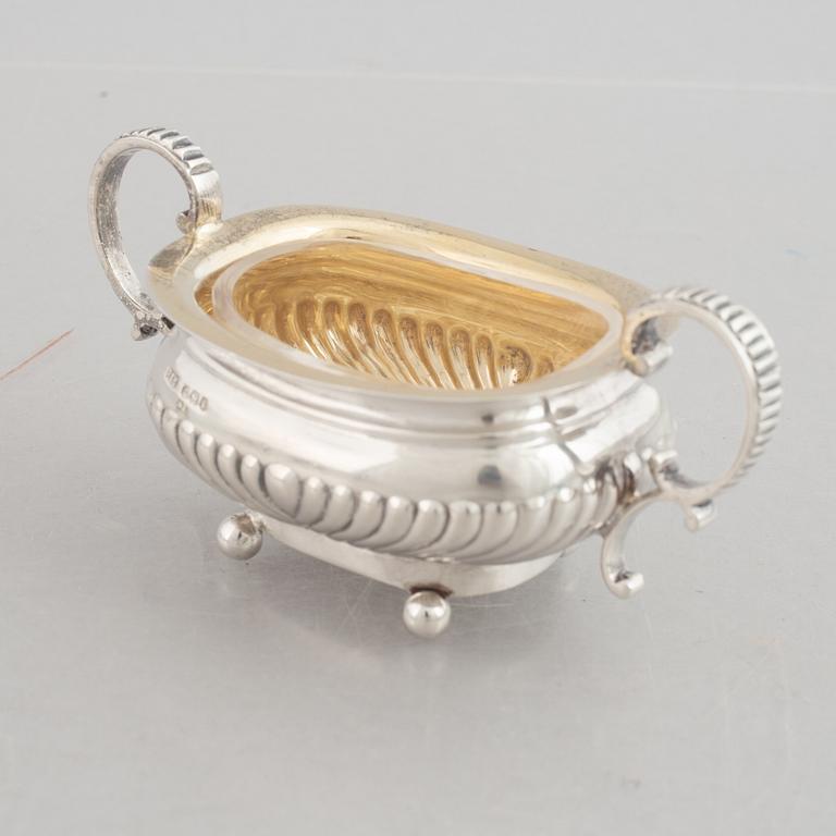 A set of four English silver salt cellars and a toast rack, including Roberts & Belk, Sheffield, England 1898.