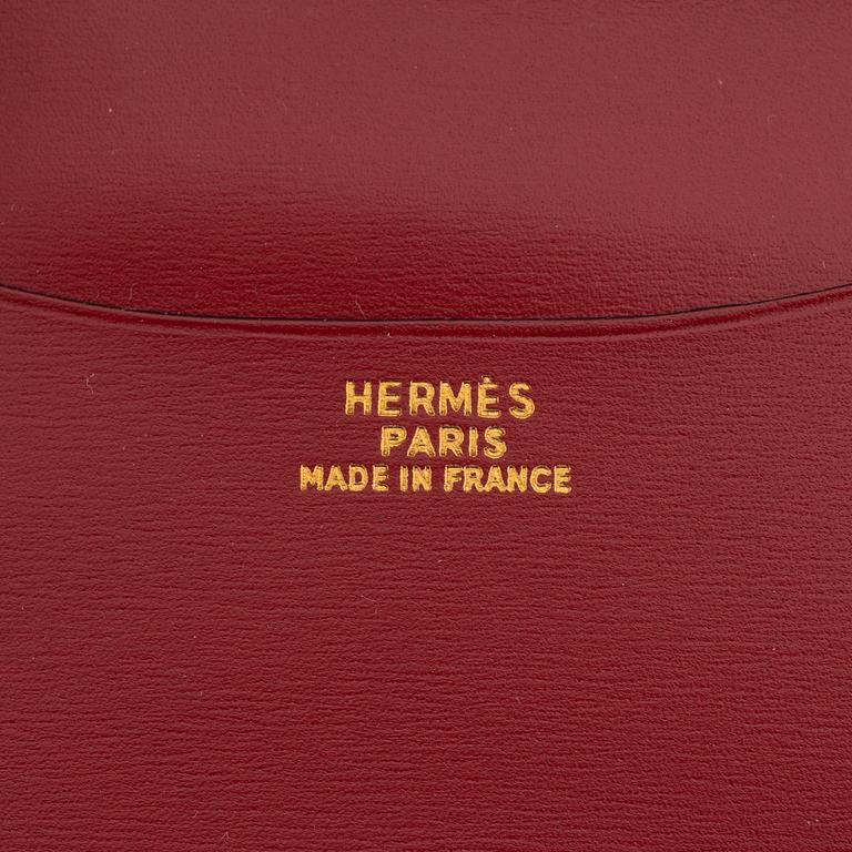 Hermès, a black leather notebook case & sterling silver pen.