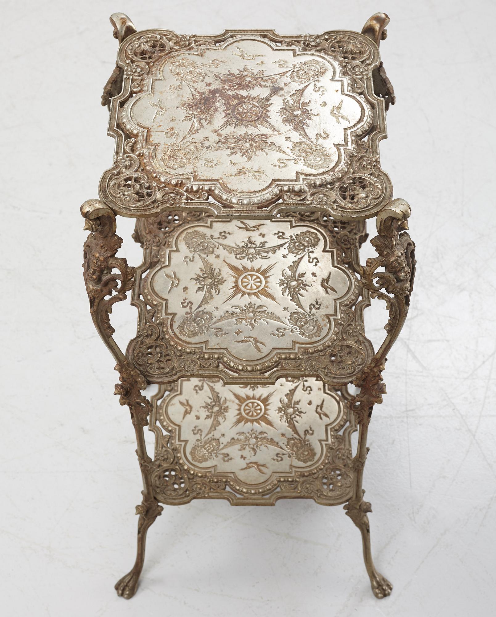 A three-tiered metal pedestal, first half of the 20th century.