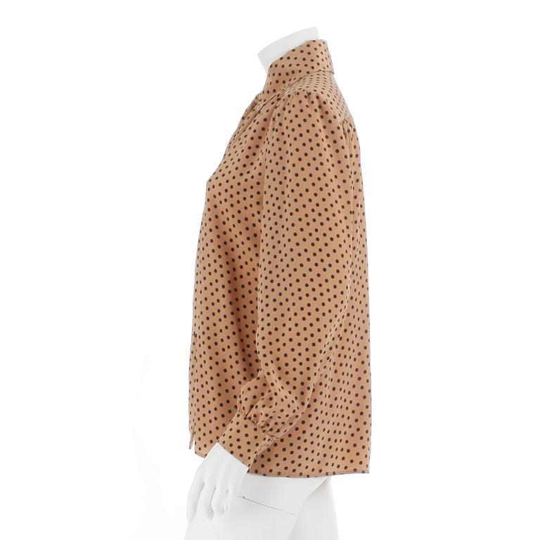YVES SAINT LAURENT, a beige and black polka dotted blouse.