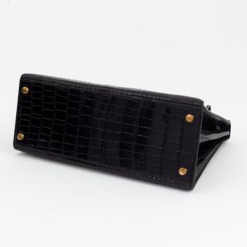 1962 black alligator 'Kelly' handbag by Hermès.