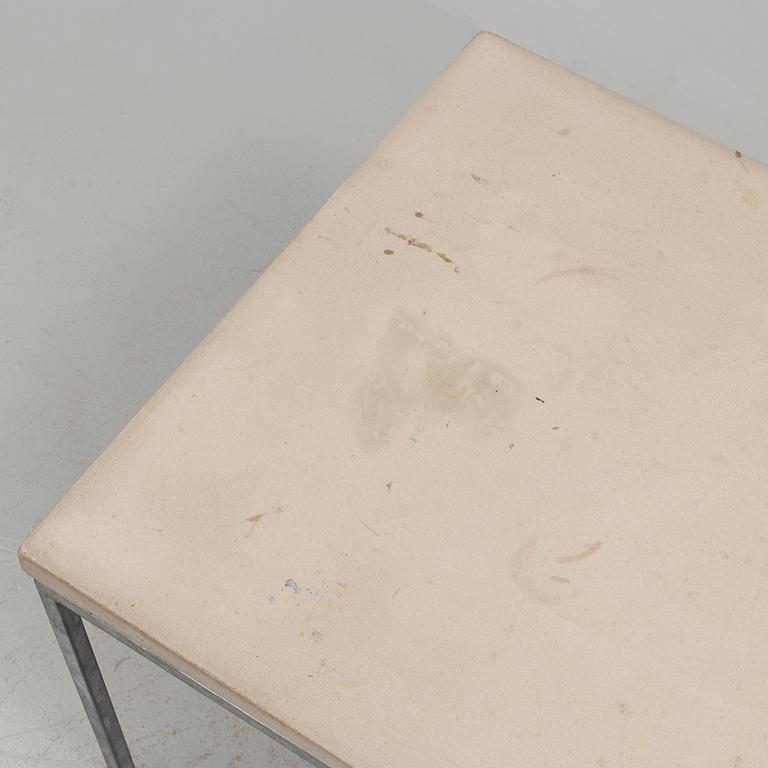 A modern sofa table with concrete top and steel legs.