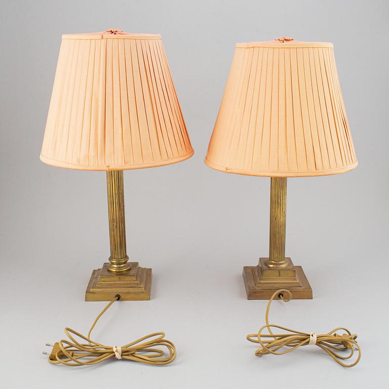 A pair of 20th century brass Empire style table lamps.