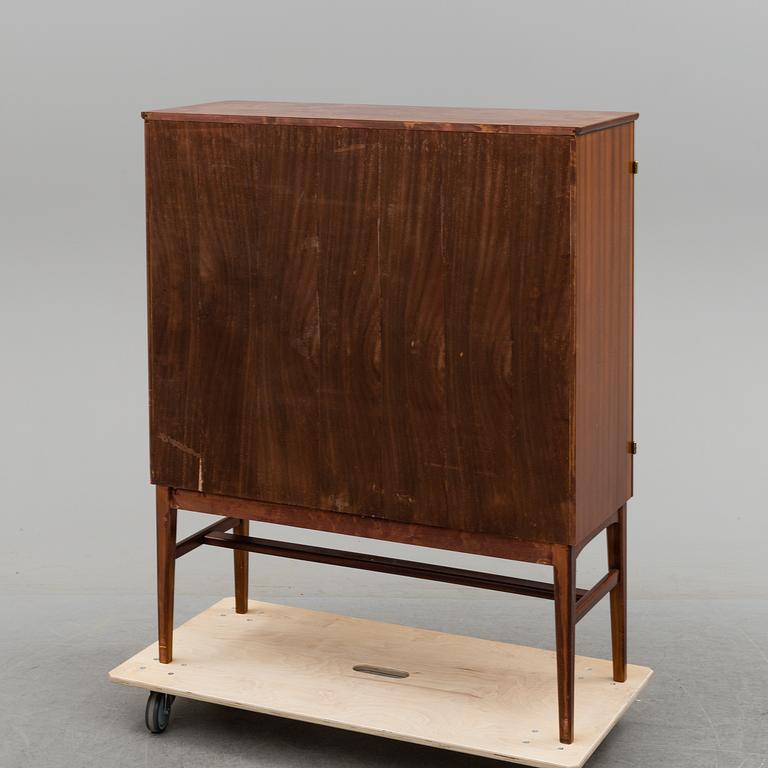 A 1950s mahogany veneered cabinet.