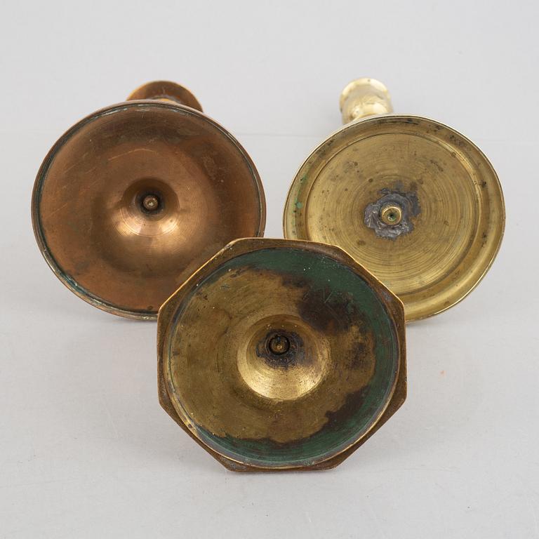 A set of five brass candlesticks, 18th / 19th Century.