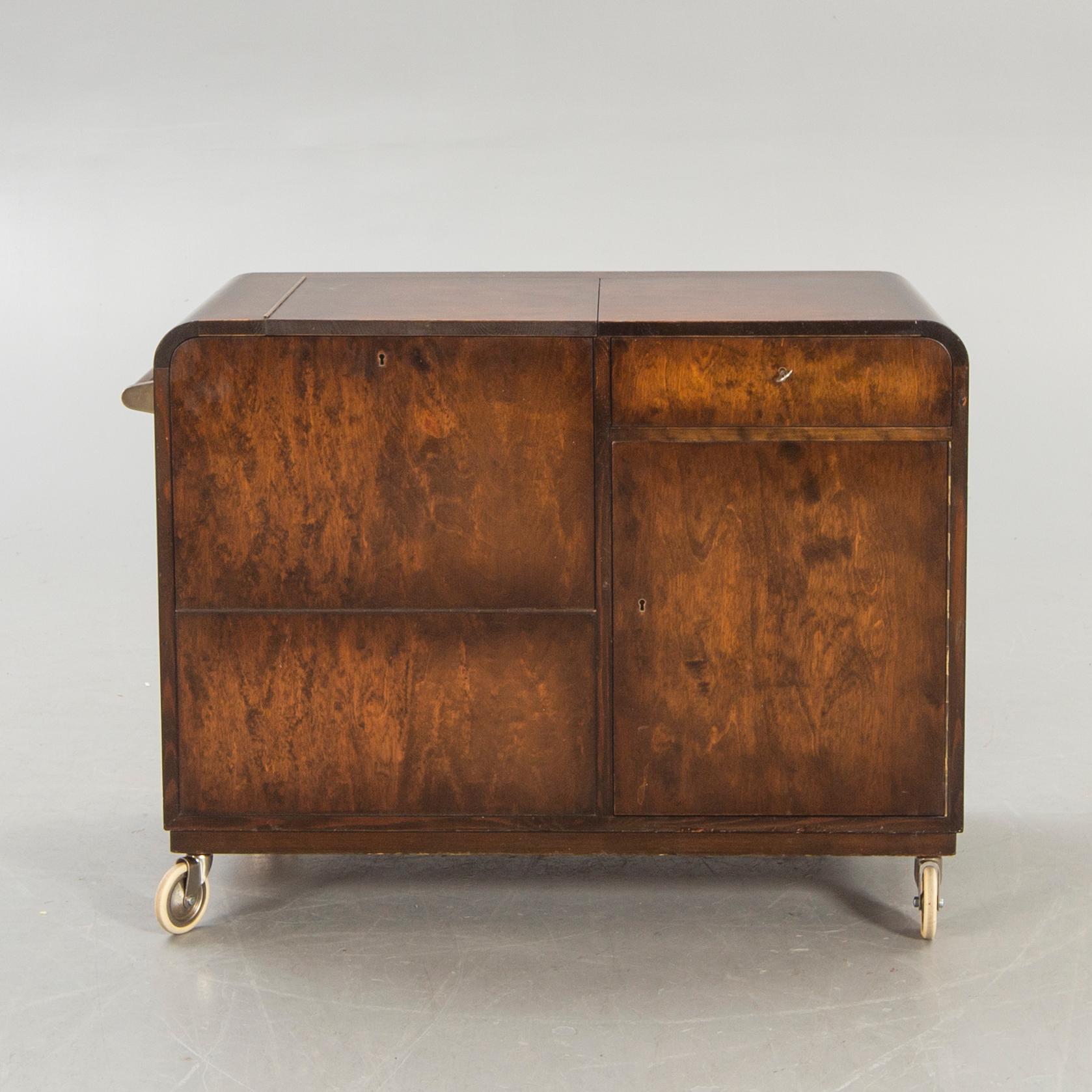A stained birch bar cabinet from NK dated 1936.