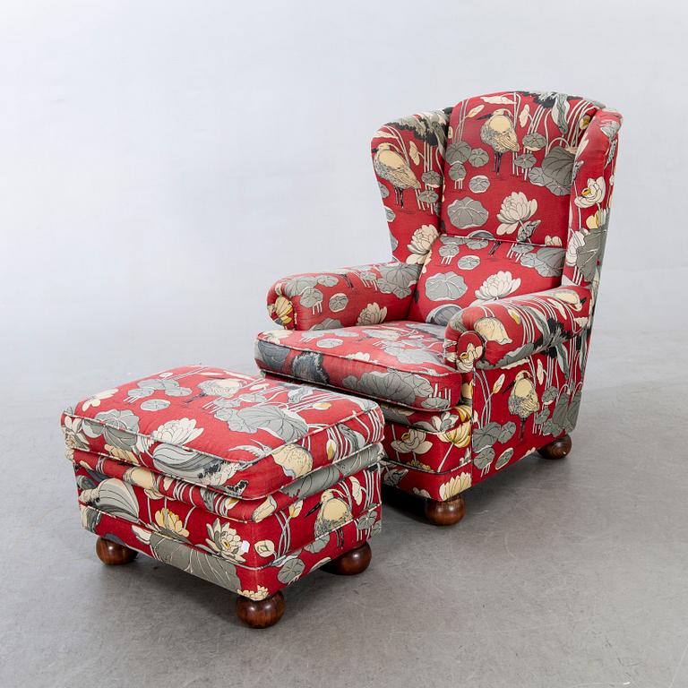 An easy chair with stool later part of the 20th century.